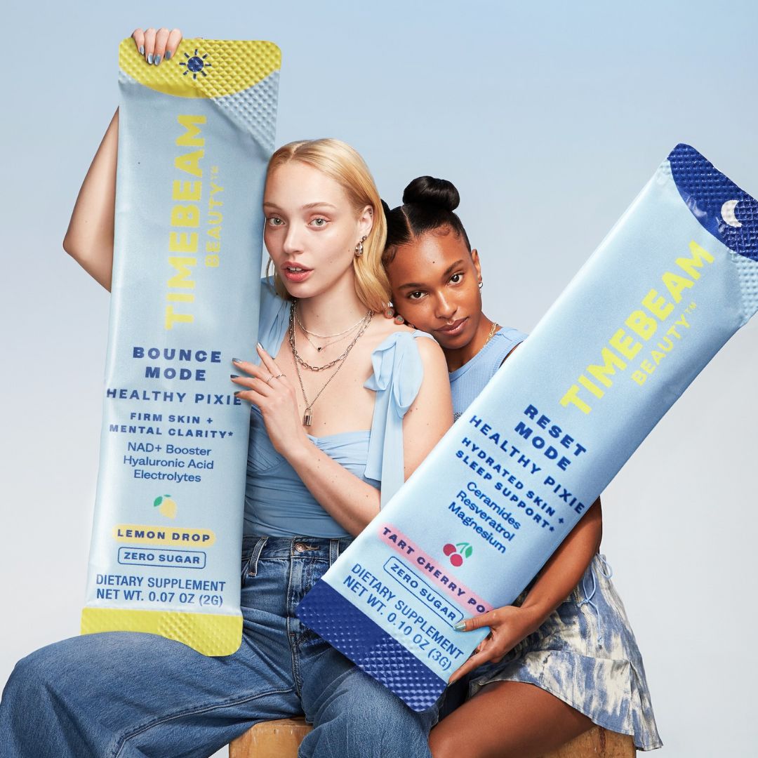 Two models holding giant Timebeam Pixie Sticks