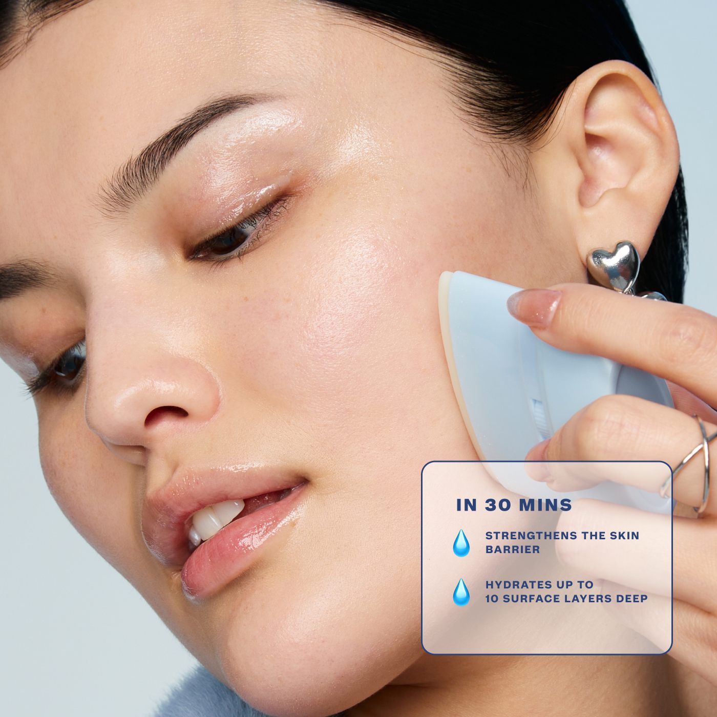 Person using a skincare device on their face with product benefits displayed.