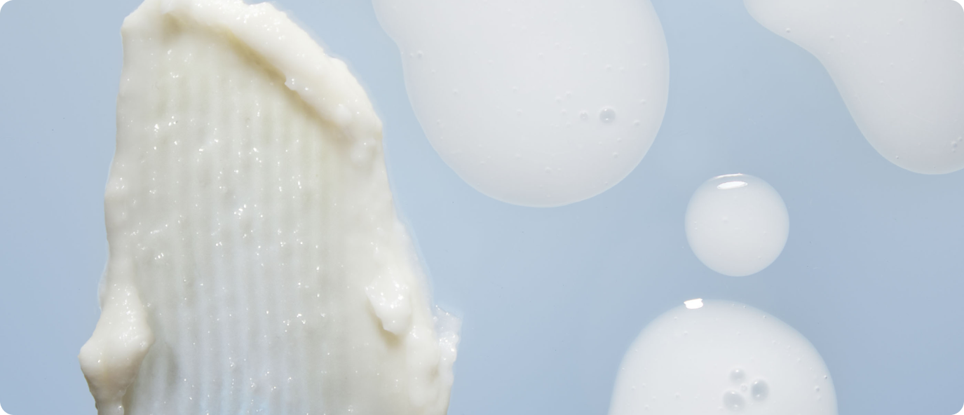 Close-up of creamy and white serum textures.