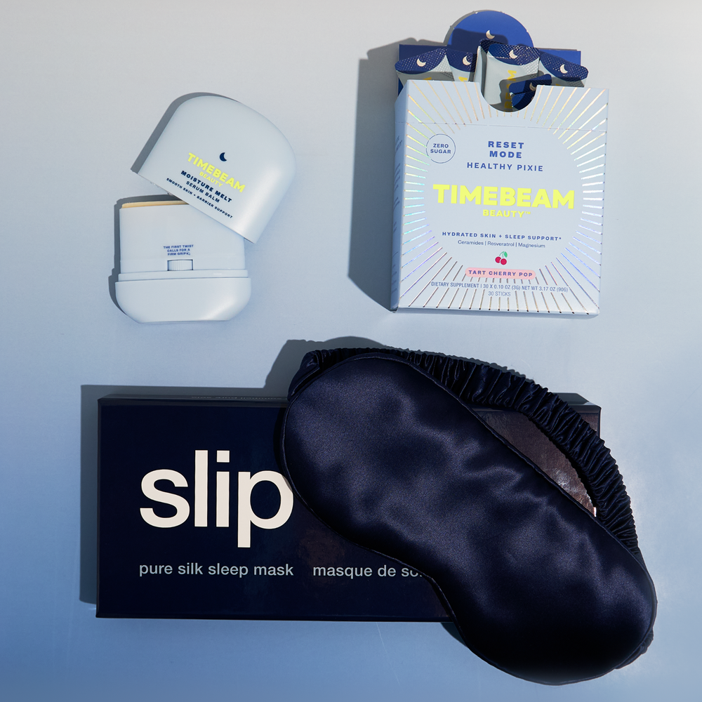 Silk sleep mask, Moisture Melt, and Reset Mode on a light blue background