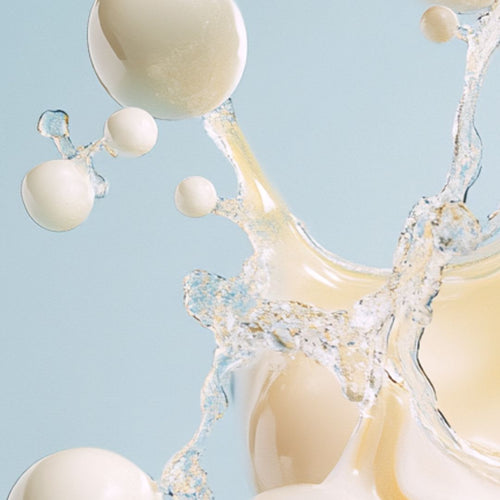 Close-up of creamy white and translucent liquid droplets and splashes.