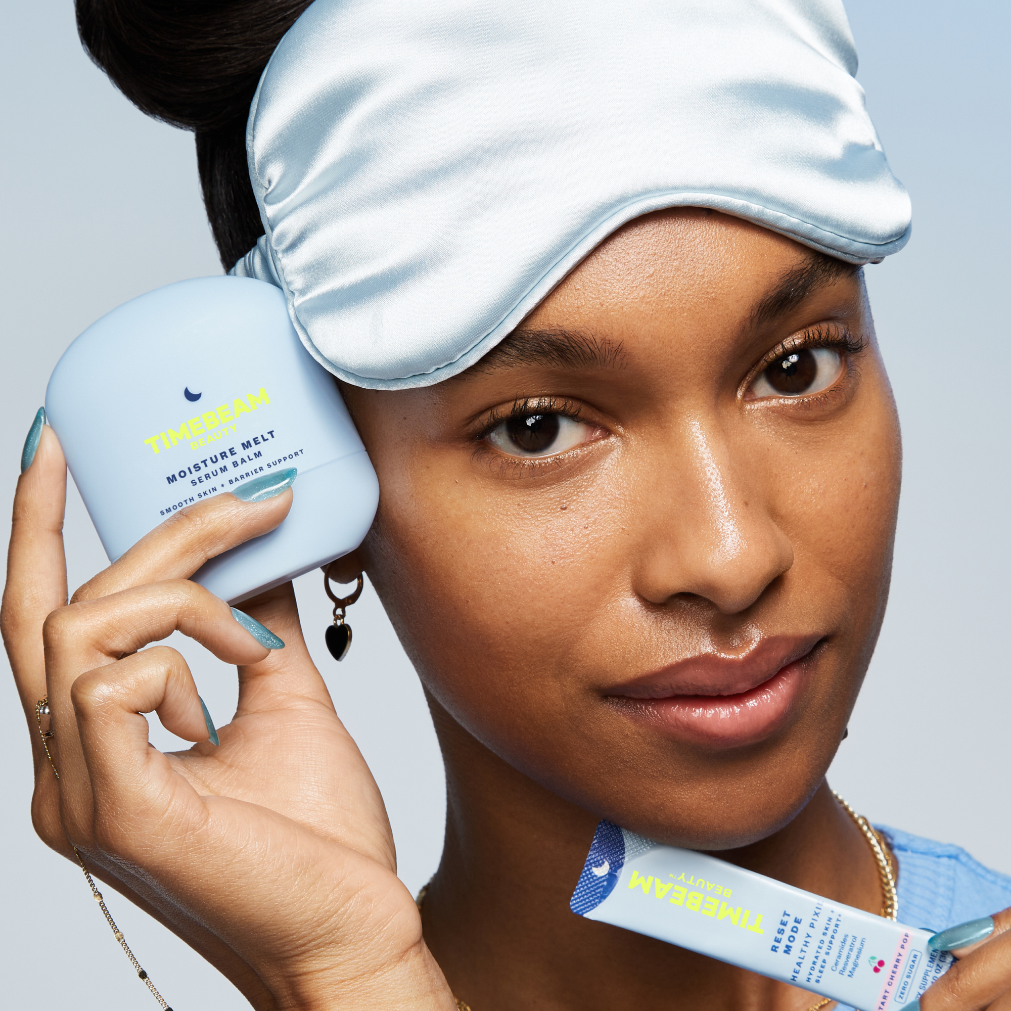 A woman with a sleeping mask on her head, holding TIMEBEAM skincare and supplements.