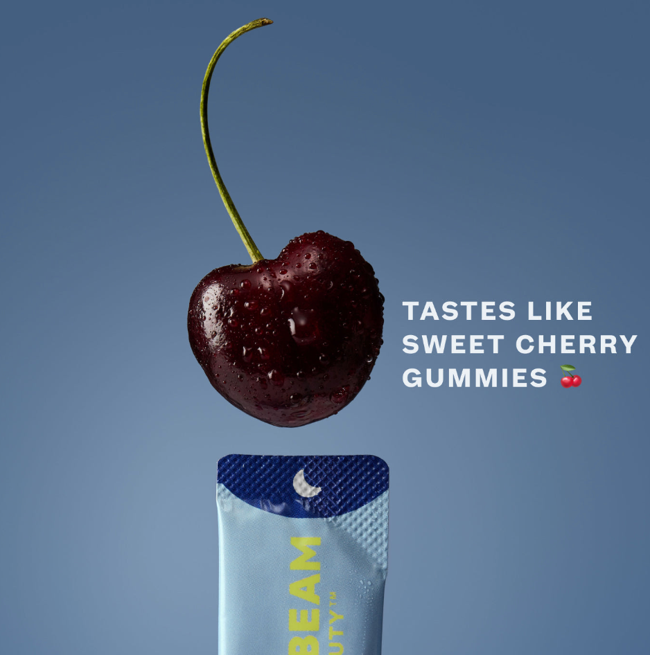 Close-up of a cherry above a TIMEBEAM supplement pouch with the text “Tastes like sweet cherry gummies”.