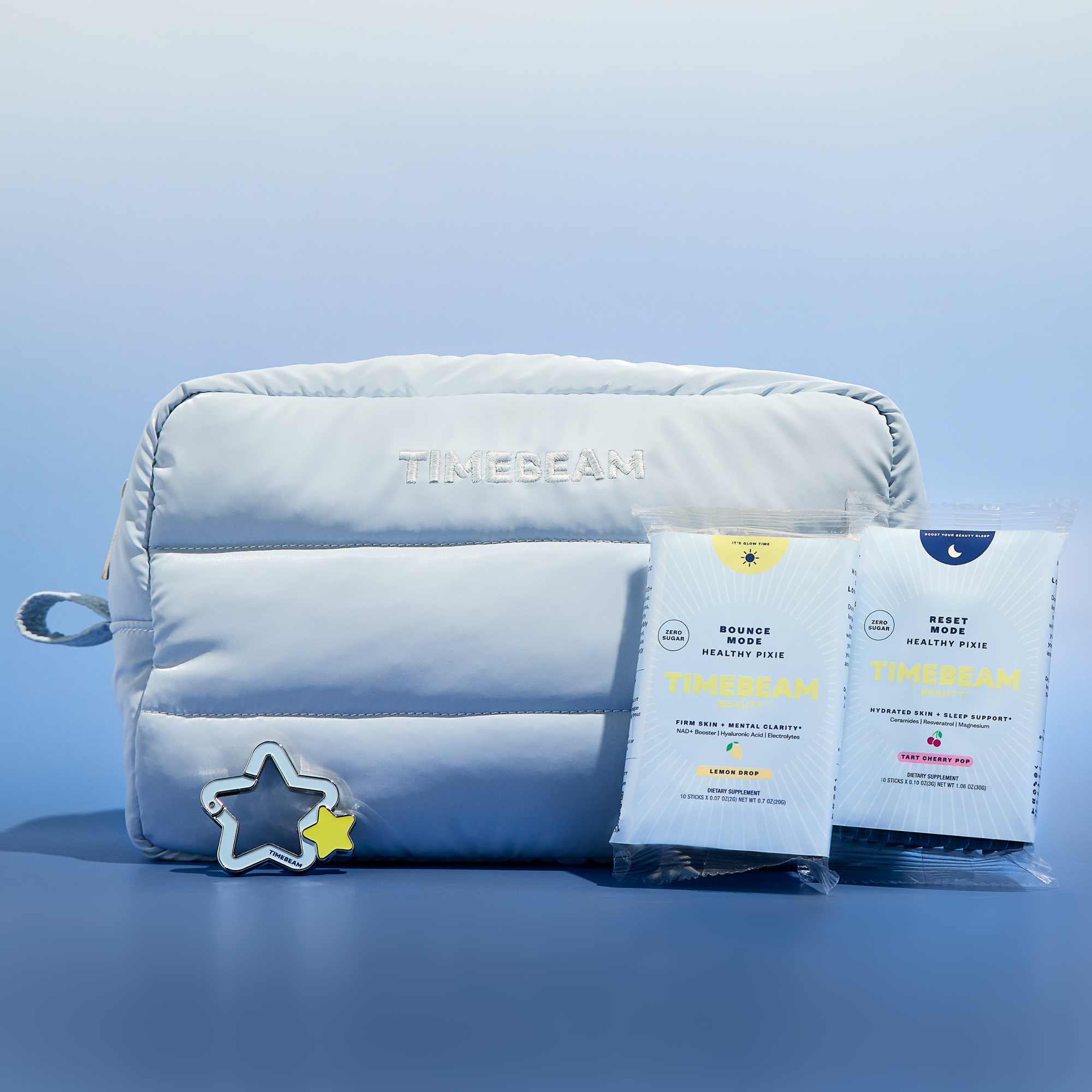 Light blue pouch with 'TIMEBEAM' branding, two packages of 'TIMEBEAM' supplements products, and a star-shaped charm on a light blue background.