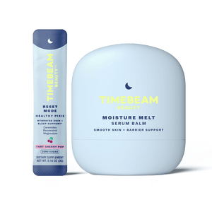 A bottle of TIMEBEAM Moisture Melt serum balm next to a pouch of Reset Mode supplements.