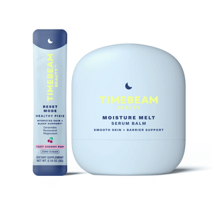 A bottle of TIMEBEAM Moisture Melt serum balm next to a pouch of Reset Mode supplements.